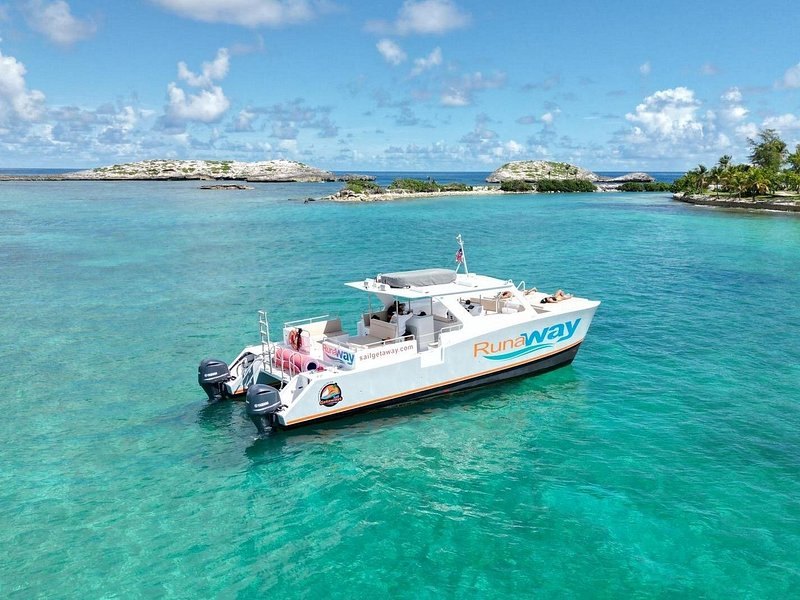 A power boat anchored off low cays in turquoise water
